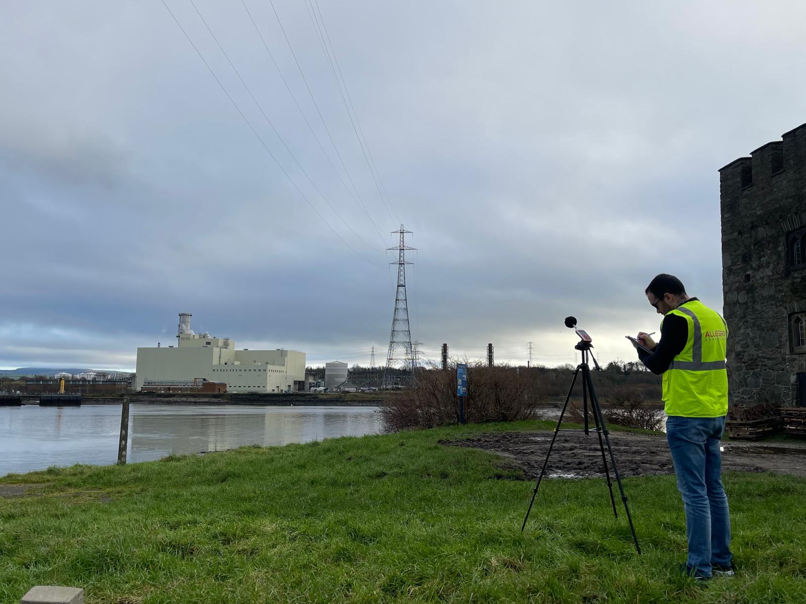 Environmental noise monitoring with a Class 1 sound level meter beside an industrial facility